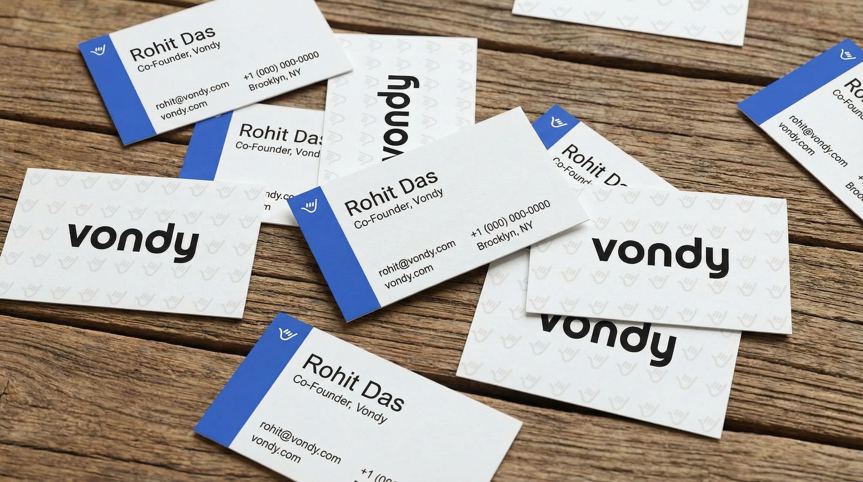 AI-generated business cards scattered on wood surface